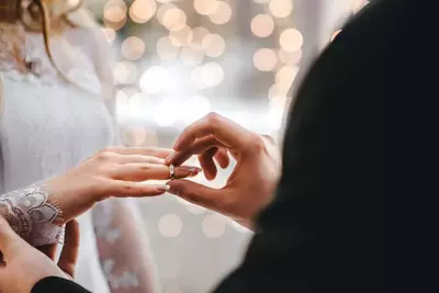 people exchanging rings at a wedding