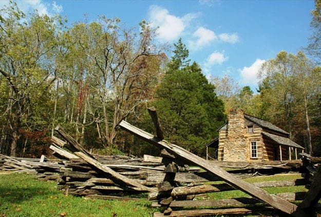 historic log cabin and split rail fence in Cades Cove