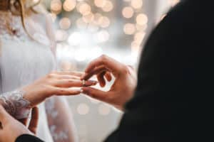 people exchanging rings at a wedding